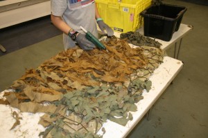 Step 9 - Cadet Risk gets busy with the glue gun to secure all the burlap lengths to the camo net